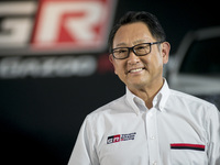 Toyota Motors president Akio Toyoda poses beside a GR86 vehicle during a press preview for the company's line of tuned road cars under the G...