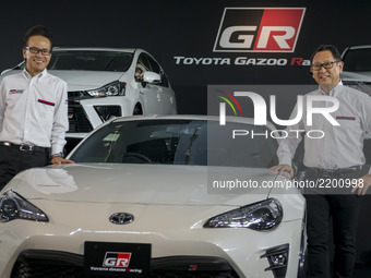 Toyota Motors president Akio Toyoda (R) and GAZOO Racing Company president Shigeki Tomoyama (L) pose beside a GR86 vehicle during a press pr...