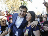 Former Georgian President and former Odessa Region Governor Mikheil Saakashvili poses for a picture with passers by in Kyiv, Ukraine, Septem...