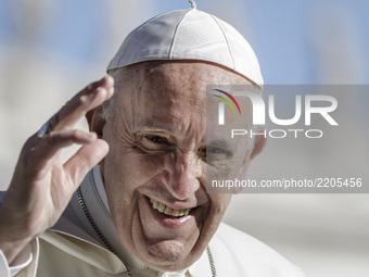Pope Francis smiles as he arrives to celebrate his Weekly General Audience in St. Peter's Square in Vatican City, Vatican on September 20, 2...