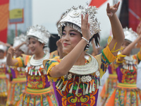 Young dancers wearing traditional hats and colorful dresses during a dance demonstration ahead of the start to the the opening stage of the...