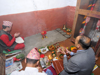 Nepalese Priests offering rituals before spreading barley seeds to grow as 'Jamara', a religious holy flower as the offering of Goddess Durg...
