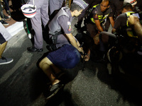 Riot police officers detain protesters during the protest against the decision of a Brazilian judge who approved gay conversion therapy in S...