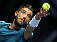 Damir Dzumhur of Bosnia and Herzegovina serves the ball to Fabio Fognini of Italy during the St. Petersburg Open ATP tennis tournament final...
