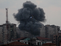 Smoke rises after an Israeli air strike on Al Zafir tower in Gaza City, 23 August  2014. (