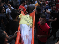  	People bury the bodies of three Palestinian boys from the Juda family and their mother, whom medics said were killed in an Israeli air str...