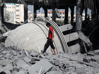 Palestinian men stand in the rubble of a mosque targeted in an Israeli airstrike in Gaza City on August 25, 2014. An Israeli air raid in Gaz...