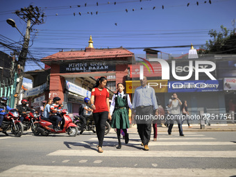 Formal Living Goddess Kumari MATINA SHAKYA in a school uniform along with her Father and sister walks towards school on her first day at Kat...