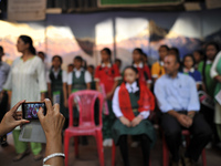 A Teacher taking pictures of Formal Living Goddess Kumari MATINA SHAKYA in a school with her Father and sister on her first day at Kathmandu...
