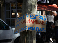 The placard reads 'School isn't a merchandise, neither our children'. More than 15000 protesters took to the streets of Toulouse against the...