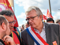 Secretary general of the French Communist Party, Pierre Laurent (C) takes part in a Metalworkers demonstration as they march with banners an...