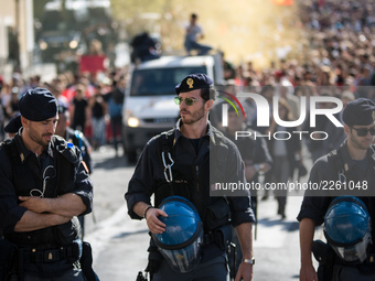 Policemen control the students protest across Italy Friday against job-placement schemes and against entry exams, as well as demanding more...