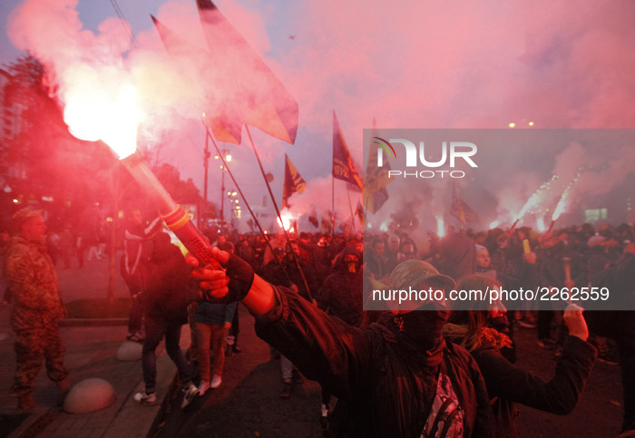 Ukrainian far-right activists from different nationalist parties hold torches during a 