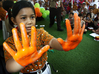 Students shown their colored hands before practicing a handwashing with soap properly, in commemoration of Global Handwashing Day commemorat...