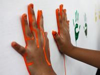 Students shown their colored hands before practicing a handwashing with soap properly, in commemoration of Global Handwashing Day commemorat...