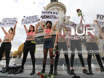 Activists from women's rights movement Femen, including leader Inna Shevchenko (4th R), stand topless while holding signs on the Place de la...