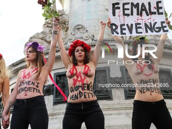 Activists from women's rights movement Femen stand topless while holding signs on the Place de la Republic in Paris on November 25, 2017 dur...