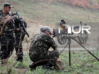 LUGANSK, UKRAINE - SEPTEMBER 11: Aidar soldiers preparetheor machine gun for fire (Photo by Sergii Kharchenko/NurPhoto)