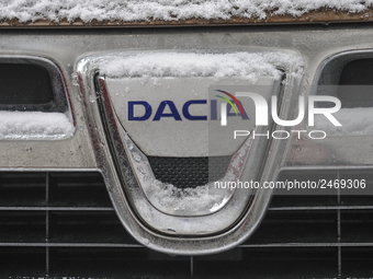 Snowflakes are seen on the badge of a Dacia car in Warsaw, Poland February 8, 2018. (