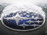 Snowflakes are seen on the badge of a Subaru car in Warsaw, Poland February 8, 2018. (