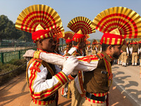 Sashastra Seema Bal (SSB) soldiers relax by massaging each other during their rehearsal for the Republic Day parade on a winter morning in N...