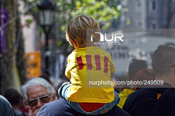 National Day of Catalonia, a chid on his father's shoulders walk  during a demonstration calling for the independence of Catalonia in Barcel...