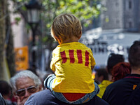 National Day of Catalonia, a chid on his father's shoulders walk  during a demonstration calling for the independence of Catalonia in Barcel...