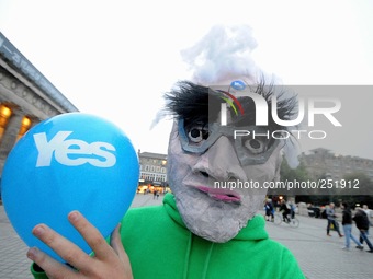 A man dressed as Alistair Darling is pushing the 