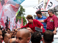 Brazil's President Dilma Rousseff (l) who is presidential candidate for the Workers Party (PT) greets her supporters during a rally of her c...