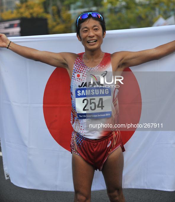 (141001) -- INCHEON, Oct. 01, 2014 () -- Tanii Takayuki of Japan celebrates victory after the men's 50km race walk of athletics at the 17th...