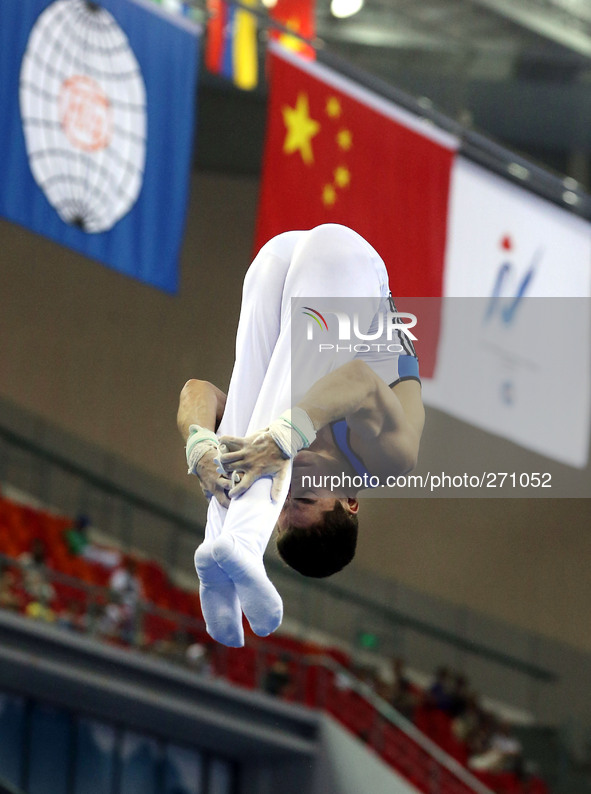 (141003) -- NANNING, Oct. 3, 2014 () -- Brazilian gymnast Lucas de Souza Bitencourt performs on the rings during the men's qualifying round...