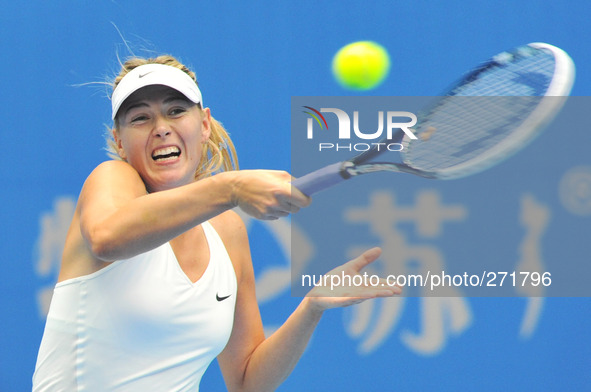 (141003) -- BEIJING, Oct. 3, 2014 () -- Maria Sharapova of Russia returns a hit during the women's quarterfinal match against her compatriot...