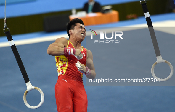 (141003) -- NANNING, Oct. 3, 2014 () -- You Hao from China performs on the rings during the men's qualifying round of the 45th Gyamnastics W...