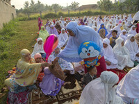 A doraemong puppets join the iedul adha pray. People in Indonesia held iedul adha pray in the morning on October 5, 2014, in Serpong, Indone...