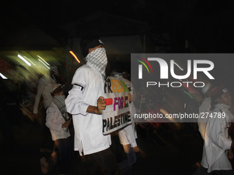 Indonesian Muslim parade in the streets with a torch, lamp and uses a unique costume themed tribute for Palestine to celebrate Eid al-Adha o...