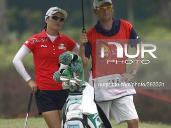 So Yeon Ryu of South Korea stands under the shading of an umbrella while waiting for her turn on the fairway of hole 10 during the second ro...