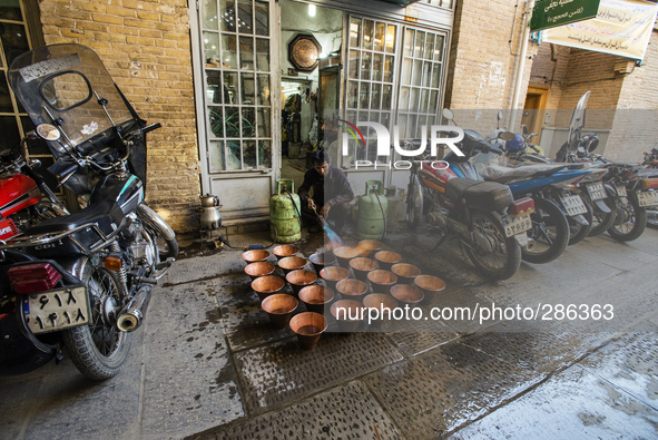 Worker burns cooper pots, Esfahan, Iran
