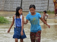 Naga residents wade through flood water after heavy rain in Dimapur, India north eatern state of Nagaland on Sunday, October 12, 2014. Hundr...