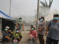 Sinabung volcano refugees wear masks to protect themselves from the thick volcanic ash following the recent eruption of Mount Sinabung in Te...