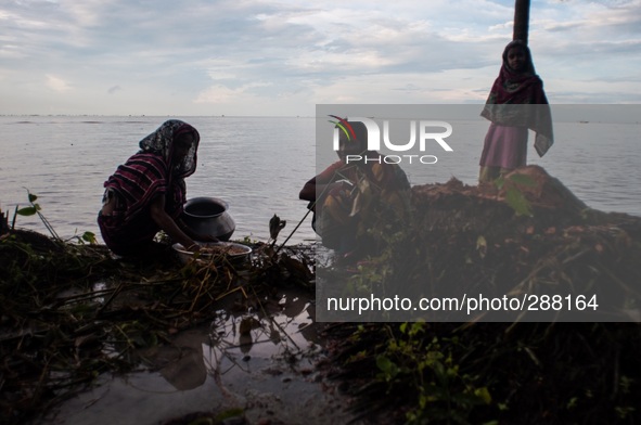 People are managing their household work at the bank of the river as they have lost their house due to riverbank erosion. Thousands of peopl...