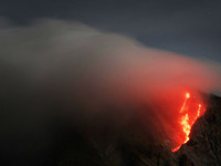 Lava flows with a giant black cloud that blew from the dome after the latest eruption of Mount Sinabung in Karo, Sumatra Island, Indonesia O...