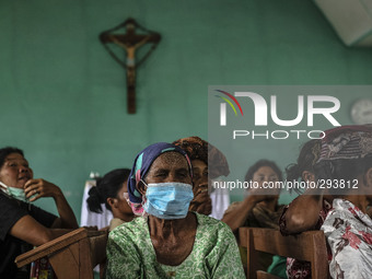 Villagers affected by the eruption of Mount Sinabung wait to get of donation on the church at Payung Village, at Karo, North Sumatera, Indon...