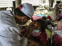 A medic health check a villager at Mardingding Village in Karo district, North Sumatra in Indonesia on October 17, 2014. The volcano, which...