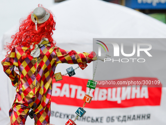 KIEV, UKRAINE - OCTOBER 21: A clown mannequin (as a advert of chamber of horrors) is seeing in front of the pre-elections campaigning tent o...