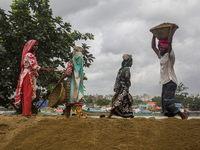 Women during the Day labors are working in a domestic port in Dhaka, Bangladesh, on 14 August 2018. (