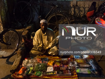 A man set up a small stall with his kid to sell items to the Muslims. (