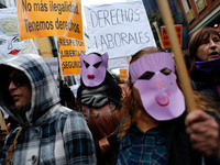Prostitutes wear masks and carry banners wiht slogans like 