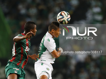 Sporting's forward Fredy Montero (R) heads for the ball with Maritimo's defender Gege (L)  during the Portuguese League  football match betw...