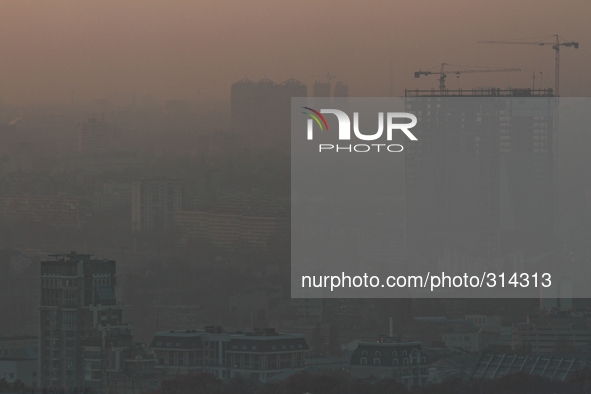 KIEV, UKRAINE - OCTOBER 30: The strong smoke is seeing as the sun sets over the Kiev city buildings. Peatlands have been burnt on the northe...