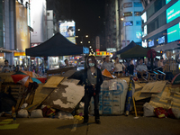 25th of October, 2015. Hong Kong, Kowloon district, Mong Kok. A pro-democracy protester guards a barricade on a street in Hong Kong.  (